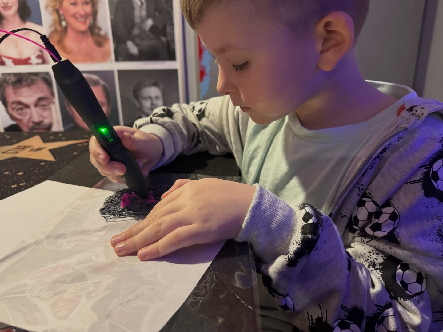 Chłopiec tworzy z długopisu 3D.